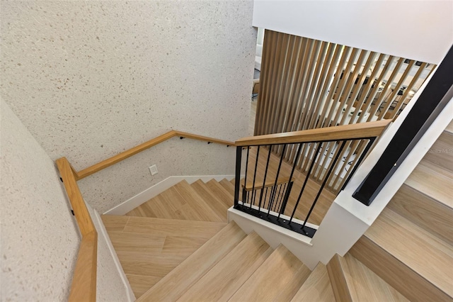 stairs featuring wood-type flooring