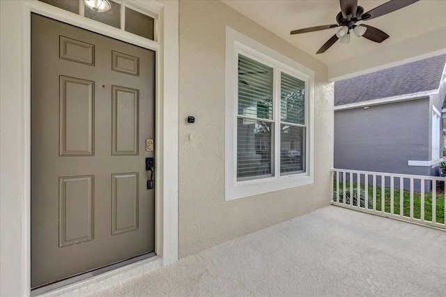 doorway to property with ceiling fan and covered porch