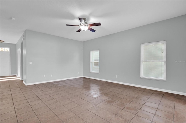 unfurnished room featuring ceiling fan and light tile patterned floors