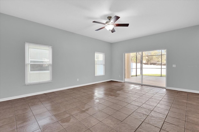 spare room with tile patterned floors and ceiling fan