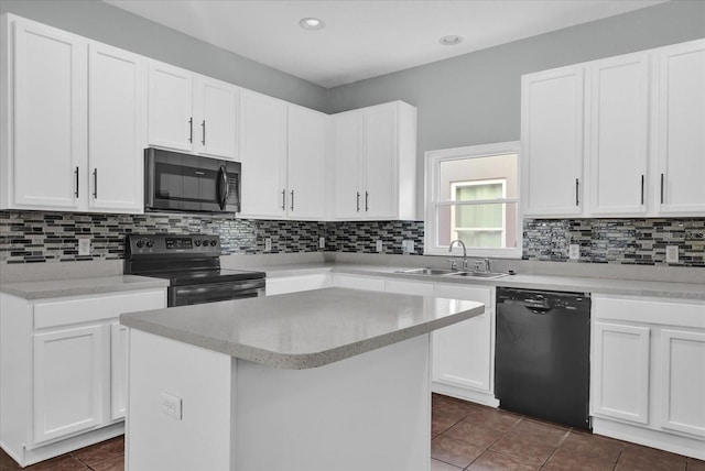 kitchen featuring sink, electric range, black dishwasher, white cabinets, and a kitchen island