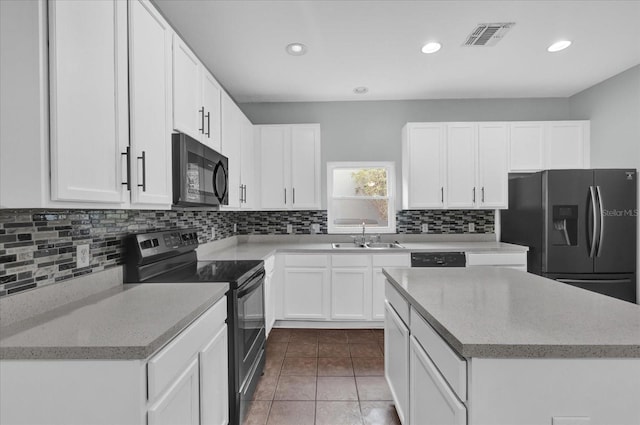 kitchen featuring sink, white cabinetry, tasteful backsplash, black appliances, and tile patterned floors