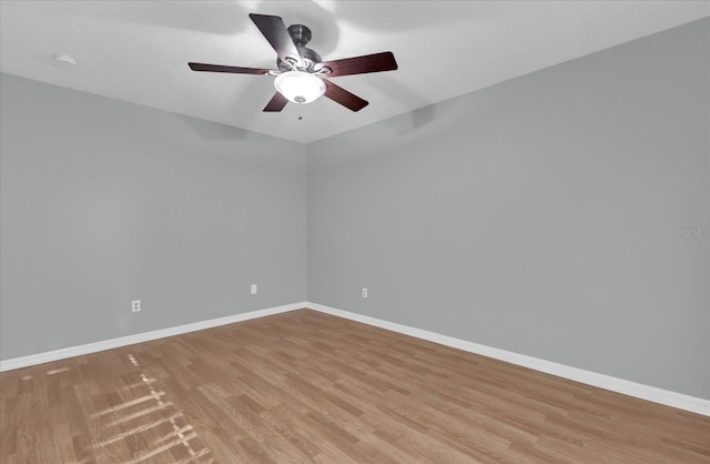 empty room featuring ceiling fan and light hardwood / wood-style floors