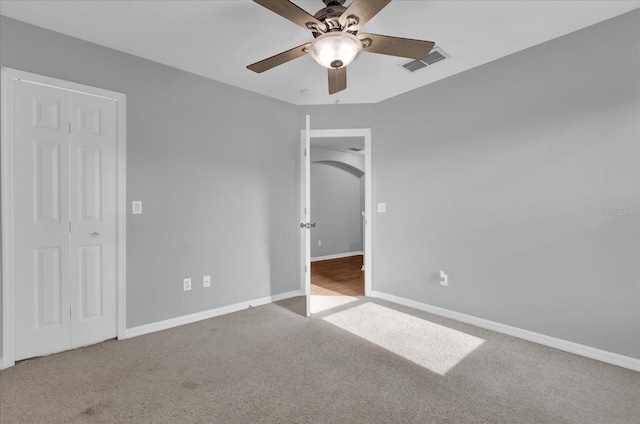 unfurnished bedroom with light carpet and ceiling fan