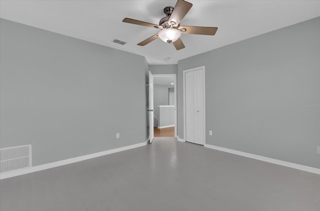 unfurnished bedroom with concrete flooring, a closet, and ceiling fan