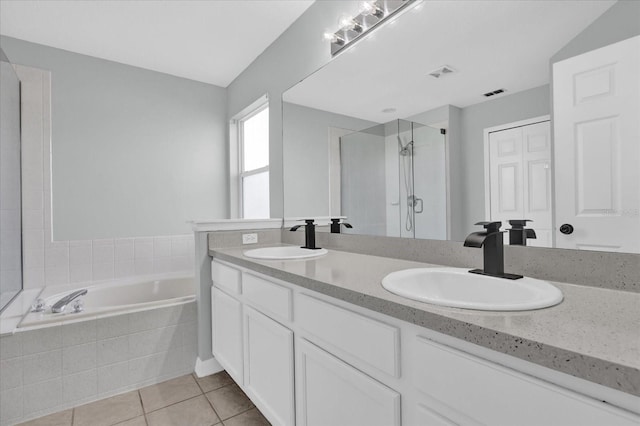 bathroom featuring tile patterned floors, vanity, and independent shower and bath