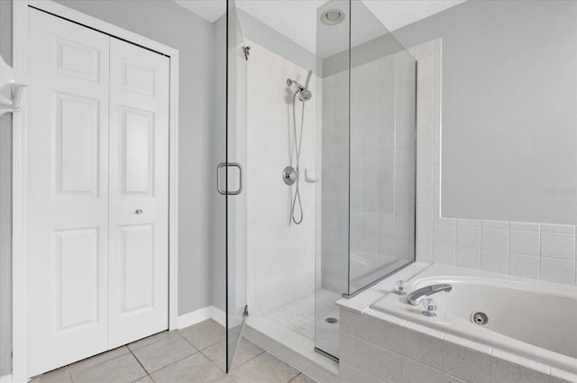 bathroom featuring tile patterned flooring and plus walk in shower