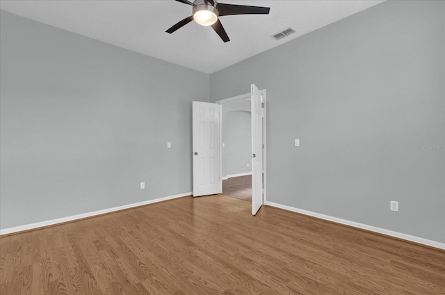 empty room with ceiling fan and light wood-type flooring