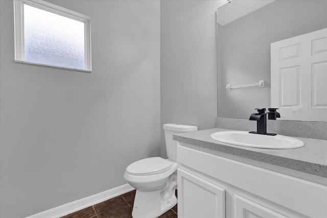 bathroom with tile patterned flooring, vanity, and toilet