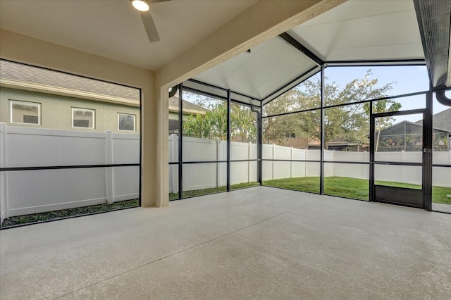 unfurnished sunroom featuring lofted ceiling with beams and ceiling fan