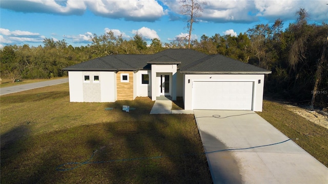 view of front of house featuring a garage and a front lawn