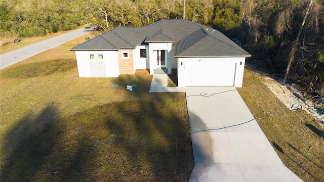 view of front facade featuring a garage and a front yard