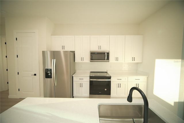 kitchen with white cabinetry and stainless steel appliances