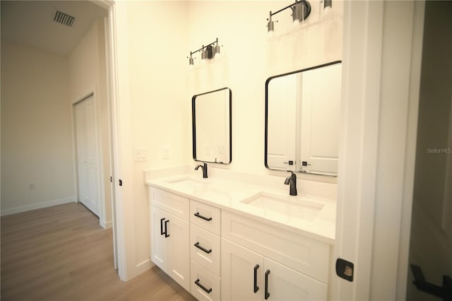 bathroom featuring vanity and hardwood / wood-style floors