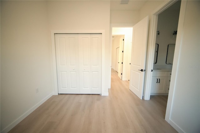 corridor with light wood-type flooring