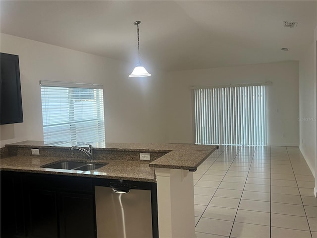 kitchen with pendant lighting, sink, light tile patterned floors, dishwasher, and kitchen peninsula