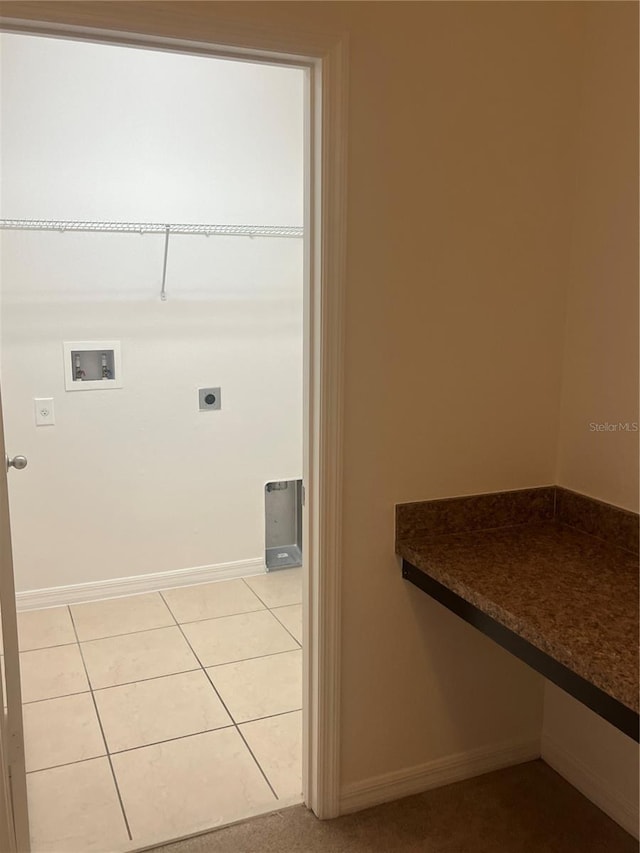 laundry area with hookup for a washing machine, light tile patterned flooring, and hookup for an electric dryer