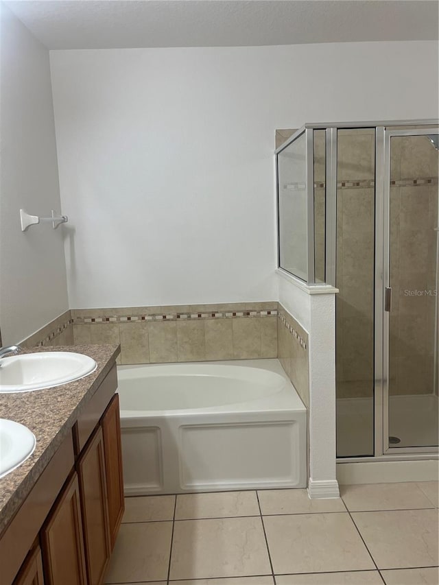 bathroom featuring tile patterned flooring, vanity, and plus walk in shower