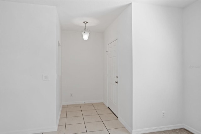 interior space with light tile patterned floors and baseboards