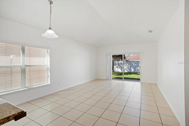 spare room with light tile patterned floors, visible vents, and baseboards