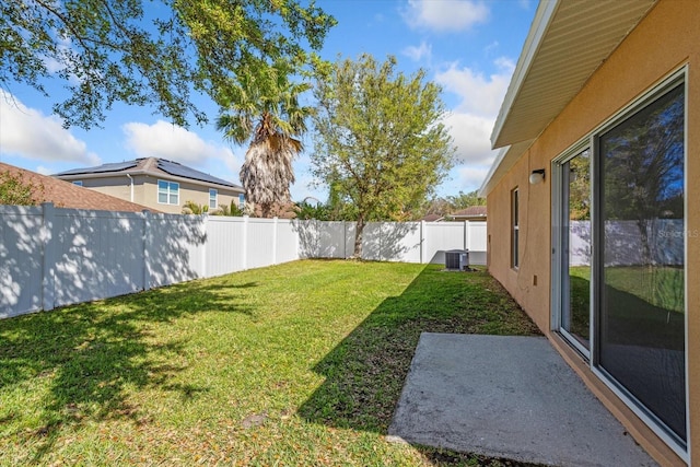 view of yard with central air condition unit and a fenced backyard