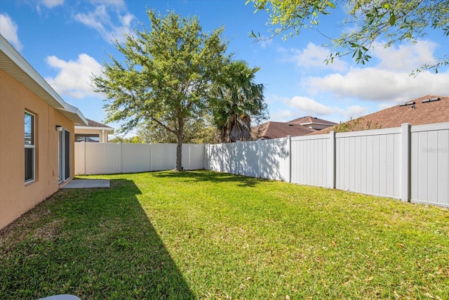 view of yard with a fenced backyard