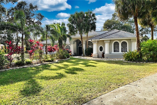 mediterranean / spanish house featuring a front yard