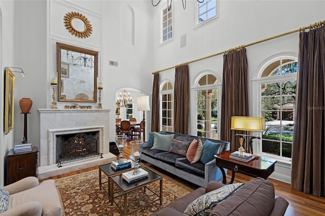 living room with wood-type flooring and a chandelier