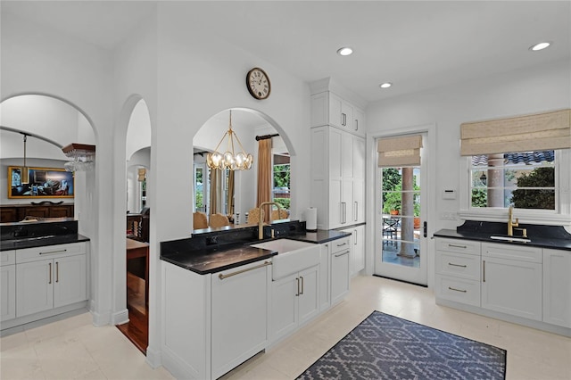 kitchen with white cabinetry, sink, and light tile patterned floors