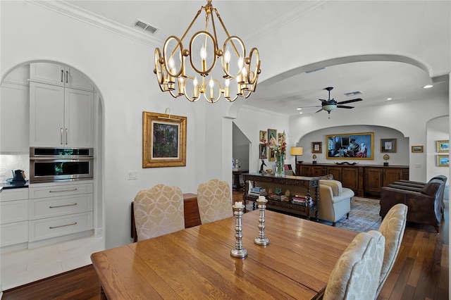 dining space with ceiling fan, ornamental molding, and wood-type flooring