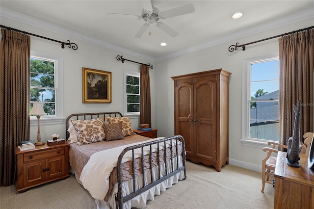 bedroom with crown molding, light colored carpet, ceiling fan, and a water view