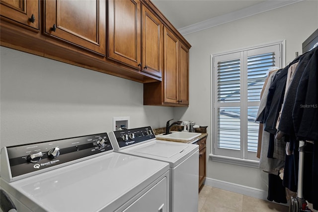 washroom featuring sink, light tile patterned floors, cabinets, independent washer and dryer, and ornamental molding