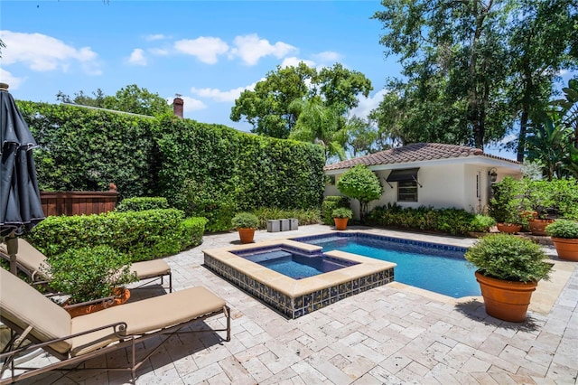 view of swimming pool featuring an in ground hot tub and a patio area