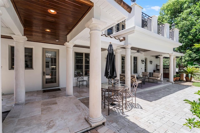 view of patio with ceiling fan, outdoor lounge area, and a balcony