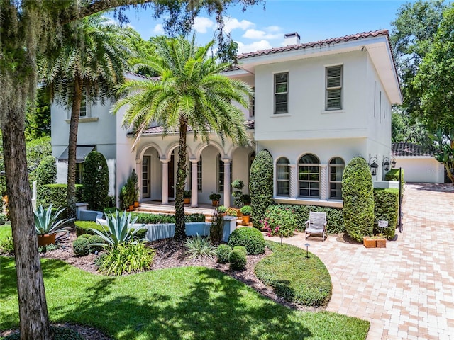 mediterranean / spanish-style home featuring a front lawn