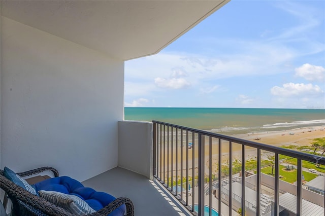 balcony featuring a water view and a view of the beach