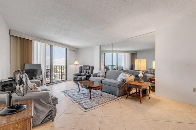 living room featuring light tile patterned floors, plenty of natural light, and a textured ceiling