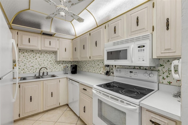 kitchen featuring sink, white appliances, light tile patterned floors, and ceiling fan