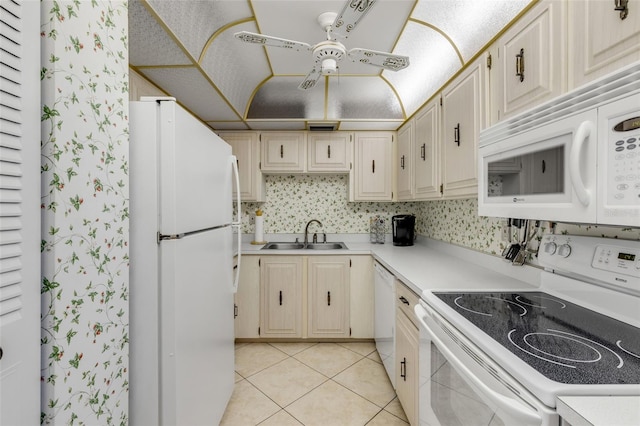 kitchen featuring ceiling fan, sink, light tile patterned floors, and white appliances