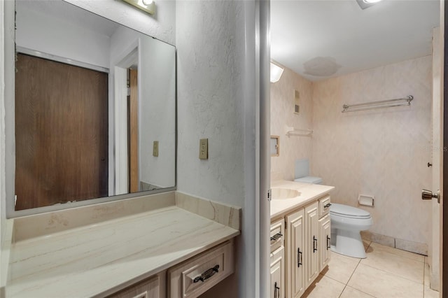 bathroom with vanity, toilet, and tile patterned flooring