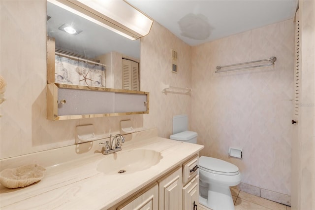 bathroom featuring vanity, tile patterned floors, and toilet