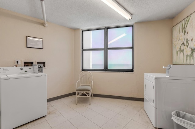 clothes washing area featuring independent washer and dryer and a textured ceiling