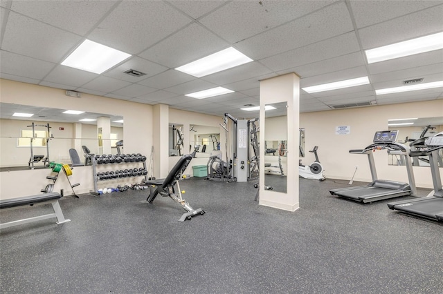 exercise room with a paneled ceiling