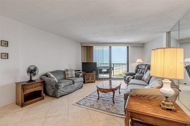1415 Ocean Shore Blvd Unit 704, Ormond Beach, FL 32176 - living area featuring light tile patterned floors, a wall of windows, and a textured ceiling