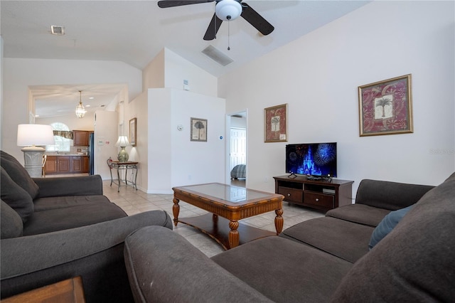 tiled living room with ceiling fan and high vaulted ceiling