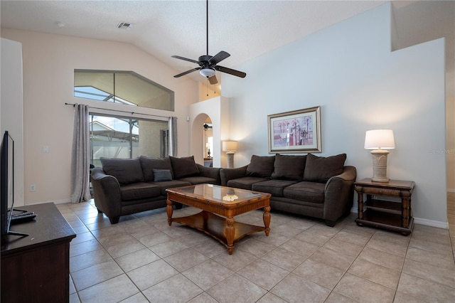 living room with ceiling fan, light tile patterned floors, a textured ceiling, and high vaulted ceiling