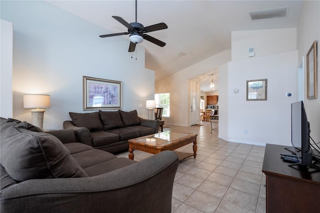 tiled living room featuring ceiling fan and high vaulted ceiling