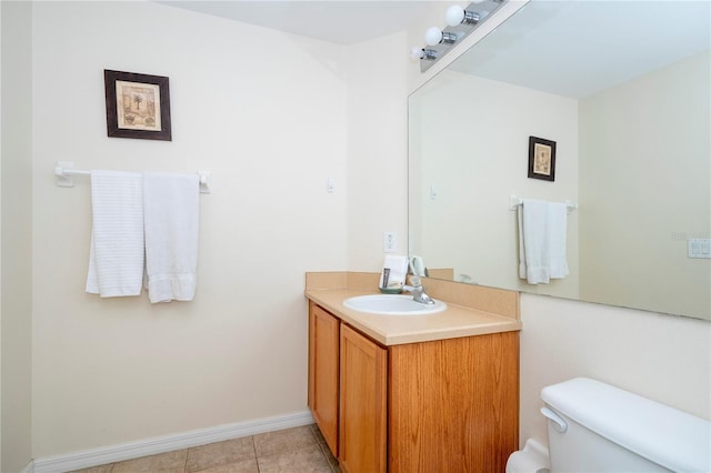 bathroom with vanity, tile patterned flooring, and toilet