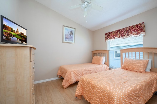 bedroom featuring vaulted ceiling, ceiling fan, and light hardwood / wood-style flooring