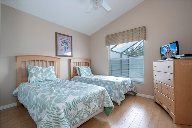 bedroom with lofted ceiling, ceiling fan, and light hardwood / wood-style flooring